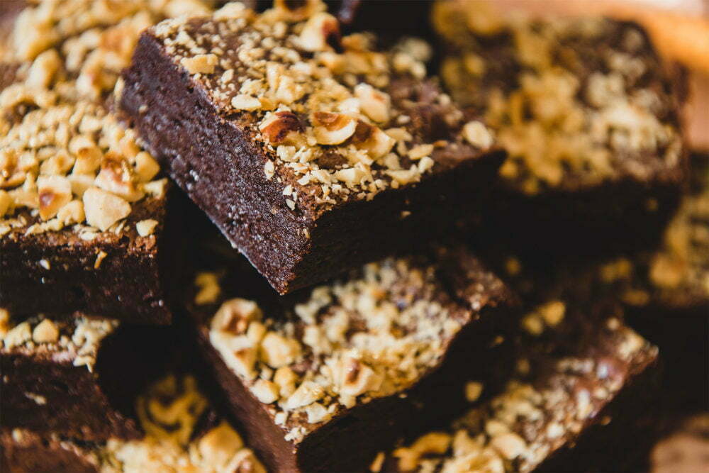 Brownies topped with hazelnuts and gold dust piled high