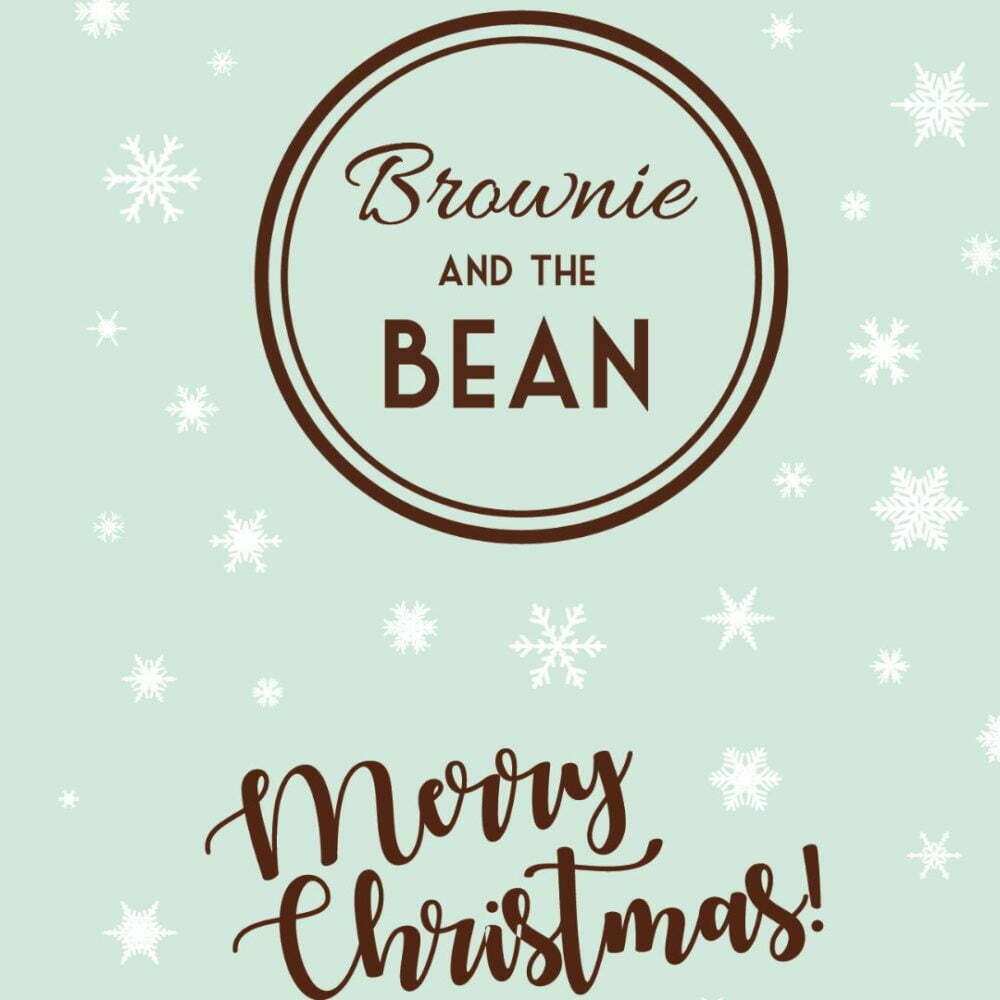 Pale mint green background with different sized snowflakes scattered across. The Brownie and the Bean logo is bold and in the middle and there is "Merry Christmas" written in scroll writing beneath.