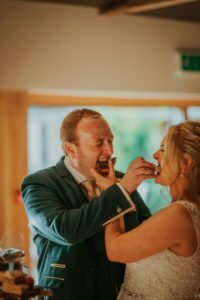 Bride and Groom feeding one another brownies on their wedding day.