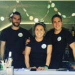 3 members of the Brownie and the Bean team are photographed behind the counter at the Aldeburgh Food and Drink Festival