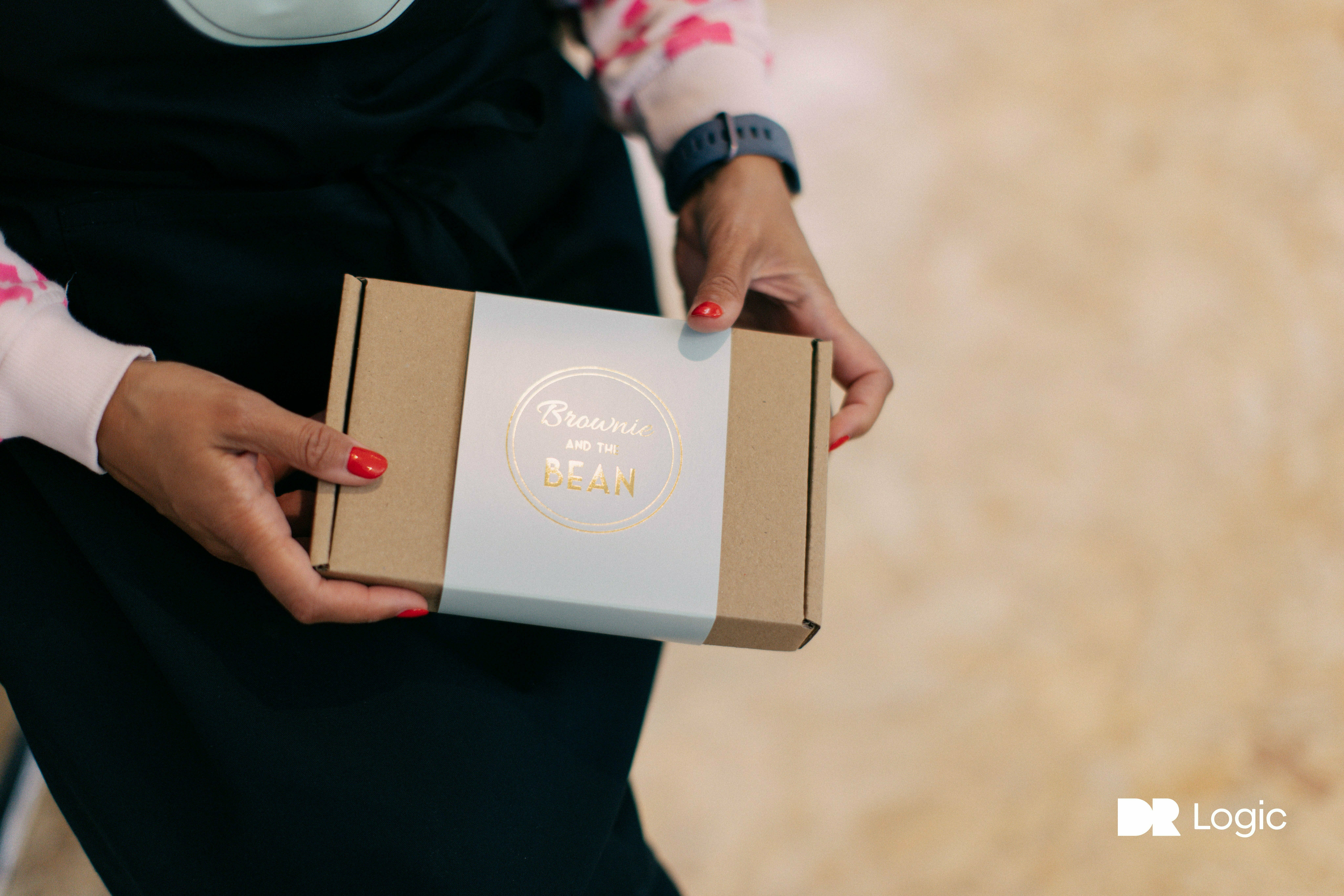 A woman is holding a brownie box in her hands