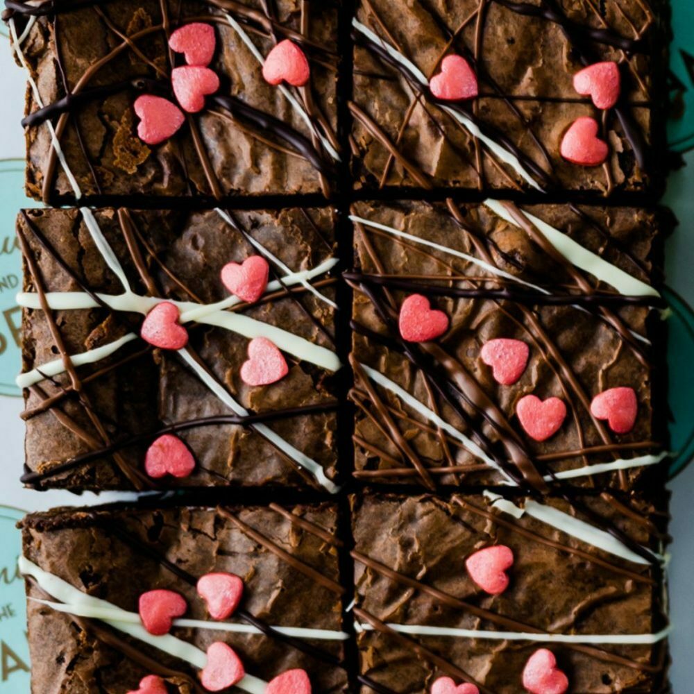 Valentine's brownies from the Valentine's Gift Hamper. Close up of chocolate brownies with heart shaped sprinkles.