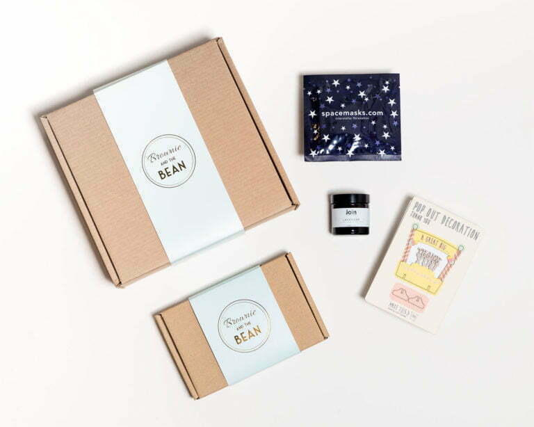 Products featured are from our corporate gifting update (Spring 2023). Corporate gifts on a white background. There is 2 Brownie and the Bean boxes, a Spacemask, candle and a card.