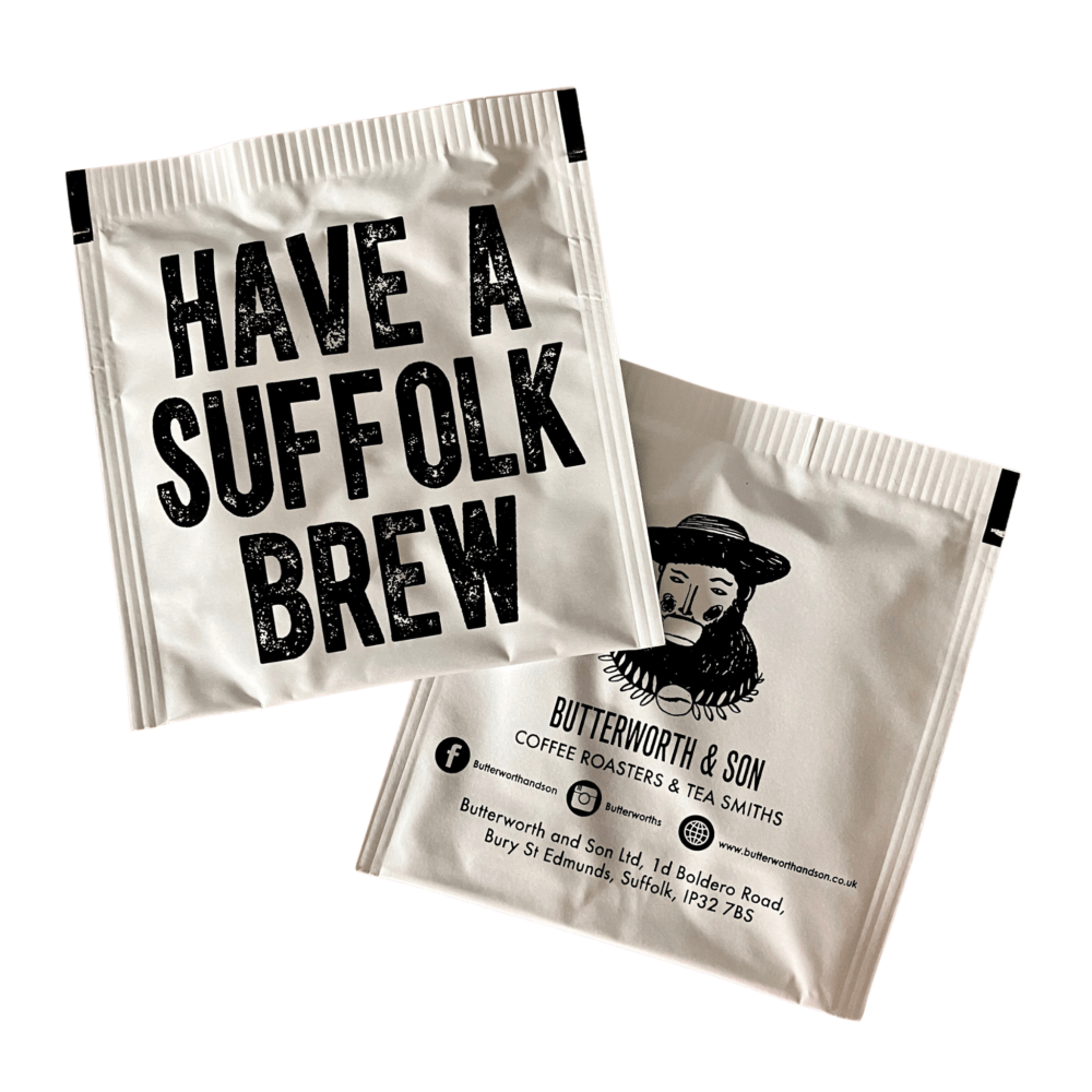 2 x Suffolk Tea Bags by Butterworth and Son. One shows the front of the tea bag which says "Have a Suffolk brew". The other tea bag has the Butterworth and Son logo and contact information on it.