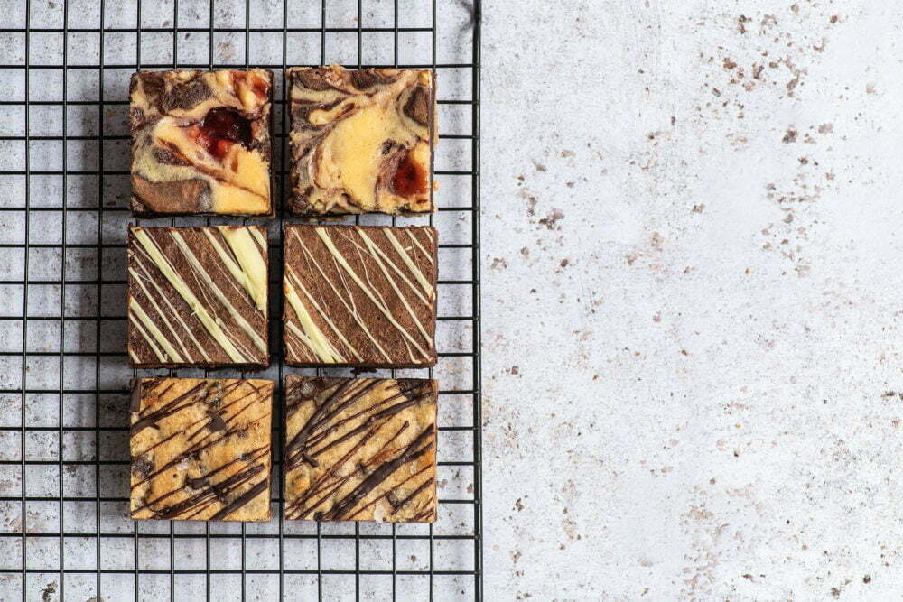 Last minute Mother's Day gifts on a baking grid. There's a marbled background and 6 brownies.