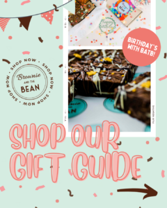 Pale mint green background with 2 x Brownie Gift Sets set into a frame of an old photograph. In large retro pink writing are the words "Shop our gift guide". The Brownie and the Bean logo is to the left and the words "shop now" are wrapped around it. There is also bunting and confetti in the branded coral pink and chocolate brown colours.