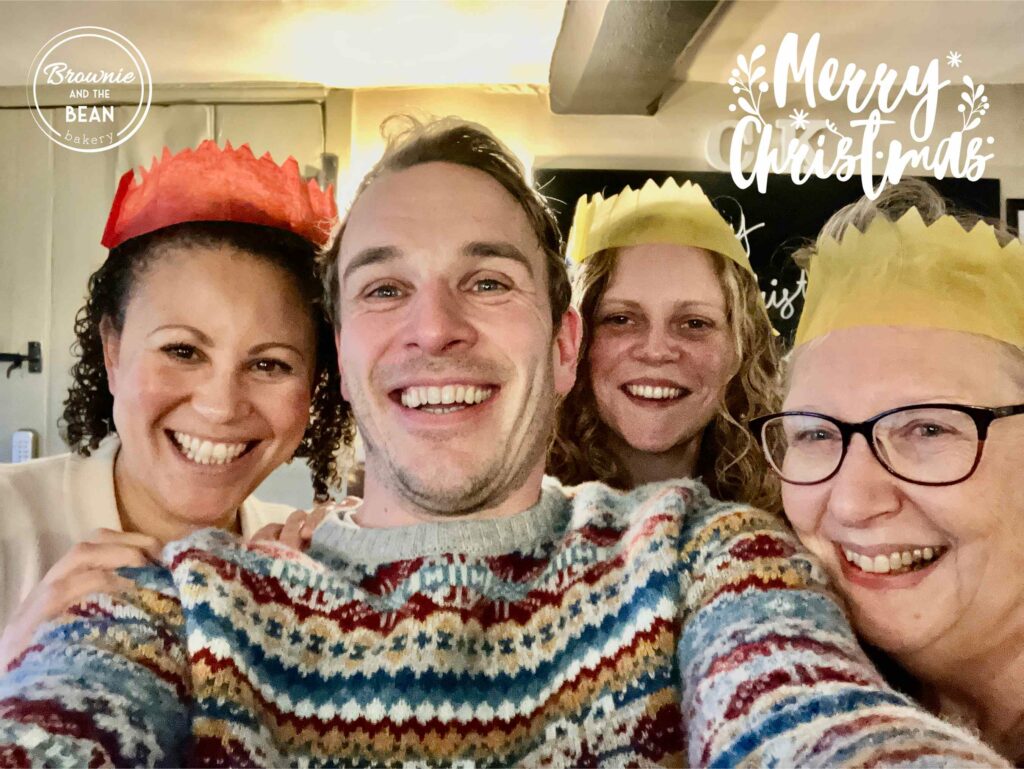 Charlotte, Luke, Harriet and Sue are in a selfie. Everyone has a big smile and is wearing festive hats. There is the Brownie and the Bean logo in the top left and the words Merry Christmas in the top right.